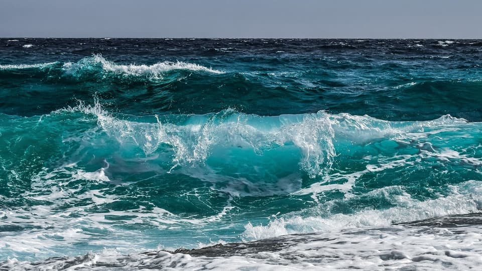 Turquoise ocean waves breaking near the shore