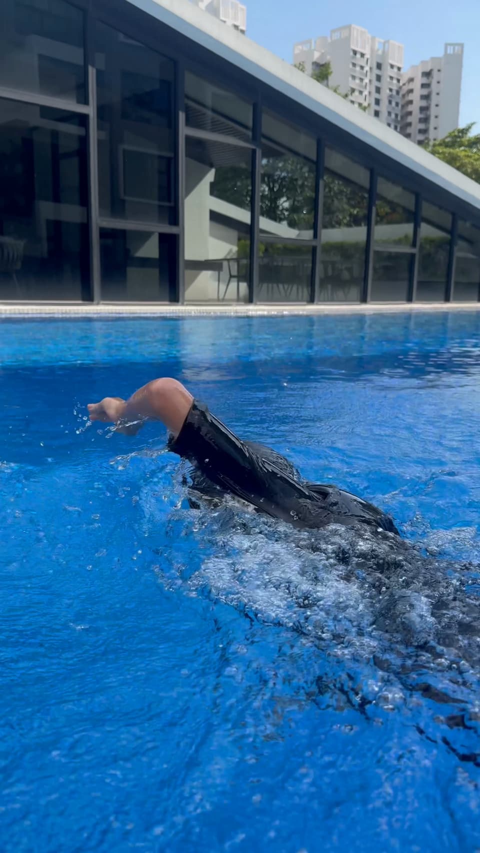 A swimmer doing freestyle in a condo pool